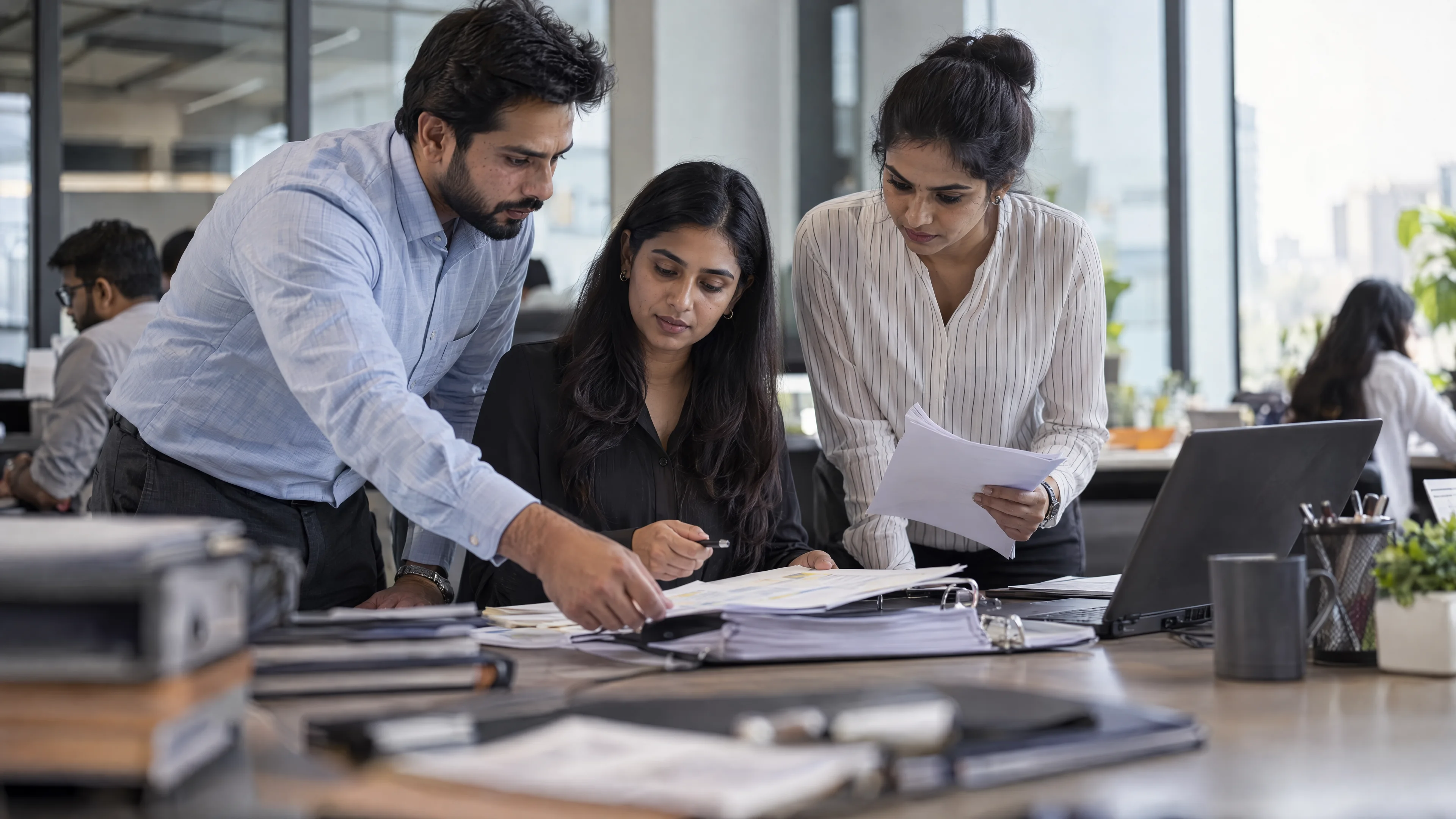 Finance operations team assembling a reconciled reporting folder.