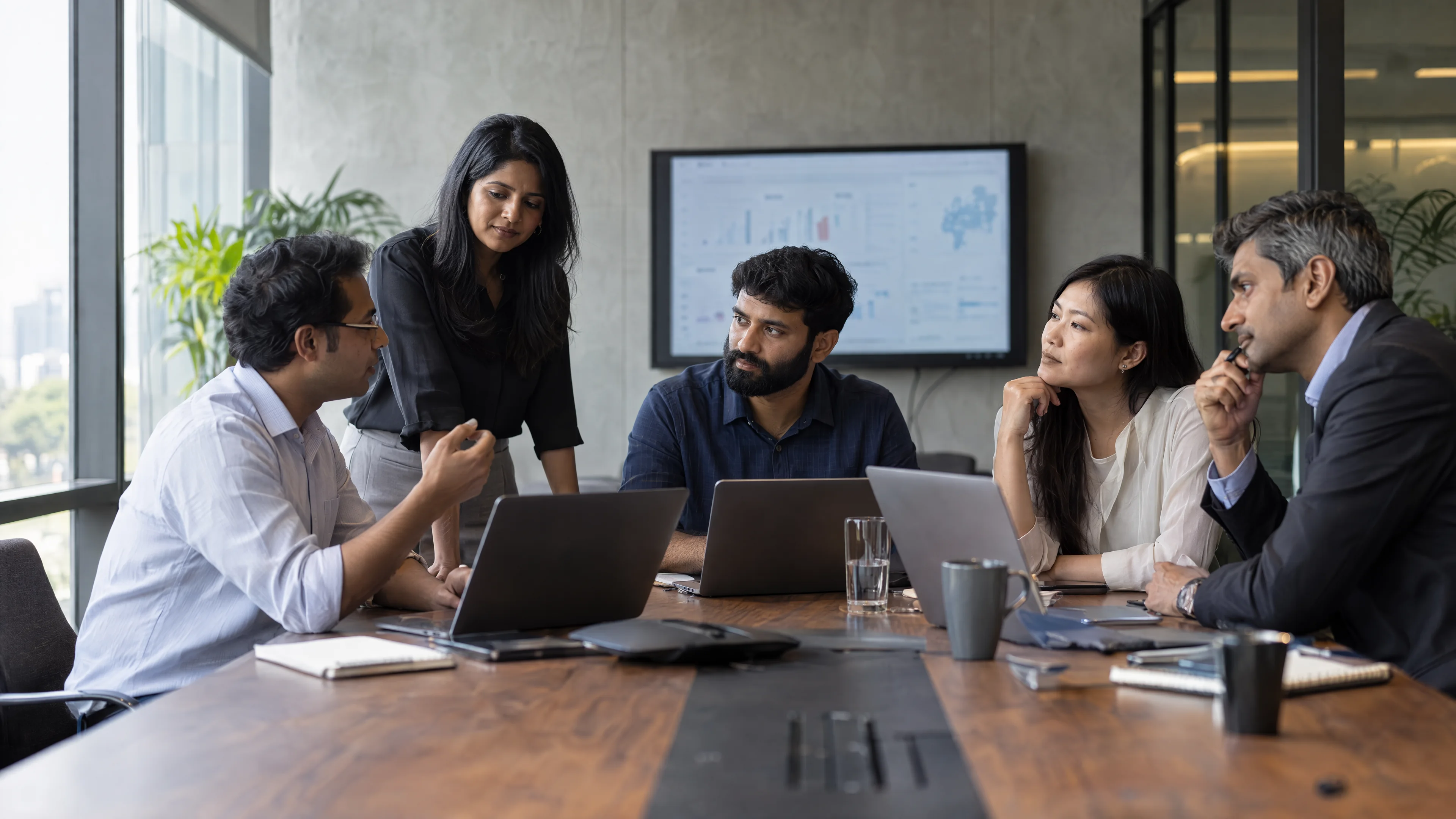 Business and technical specialists discussing a project in a meeting room.