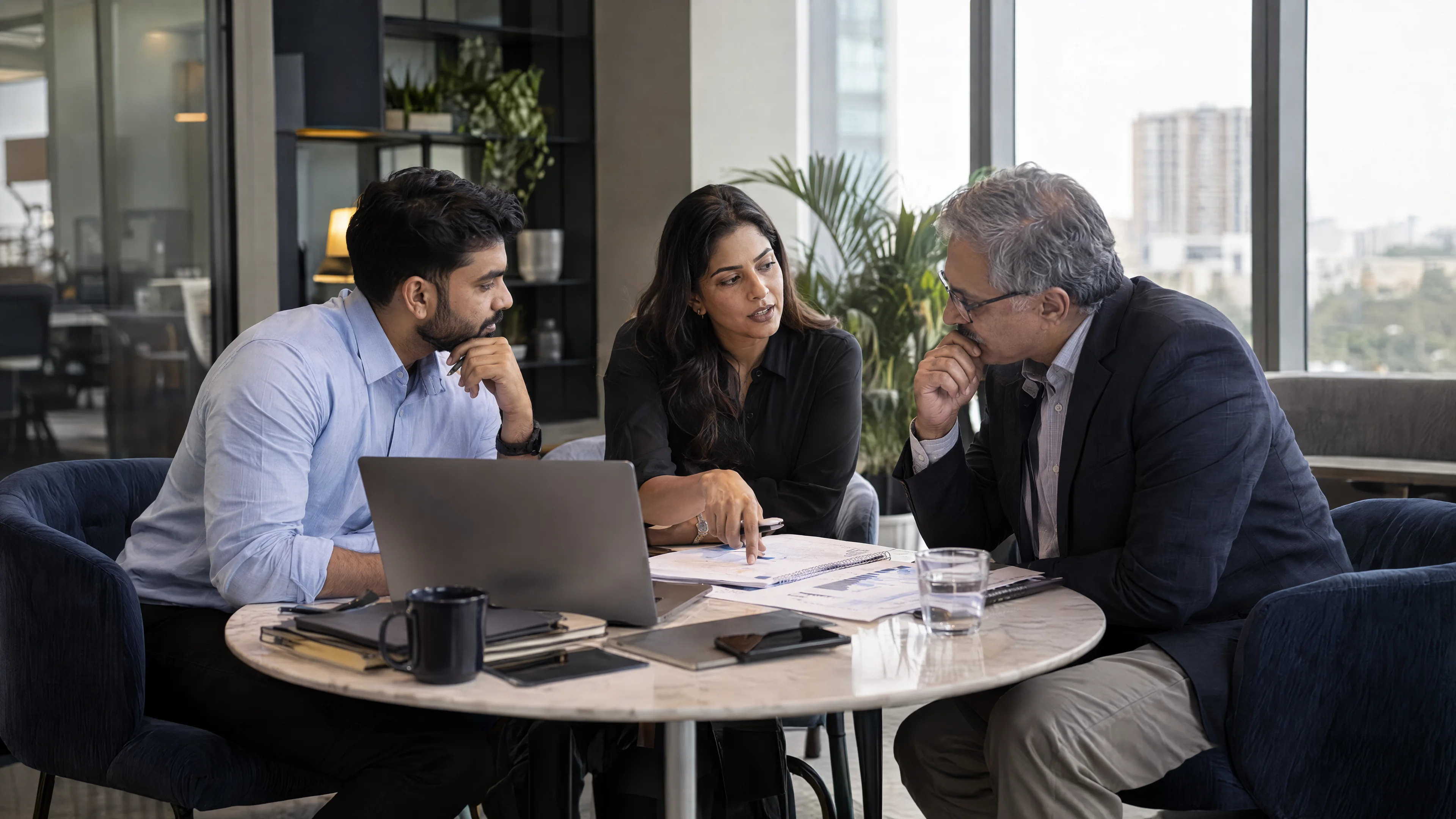 Colleagues discussing an annotated project plan around a table.